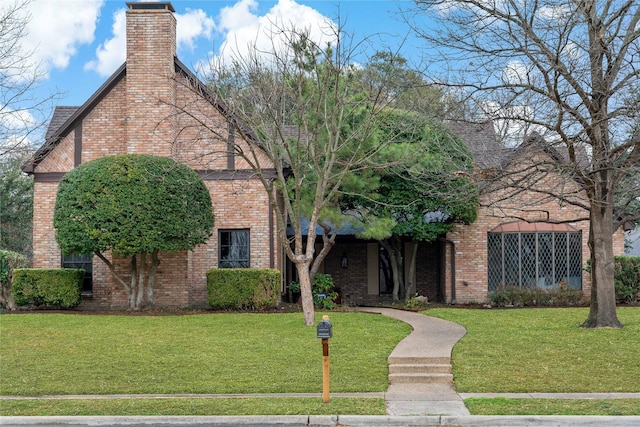 tudor-style house with a front lawn