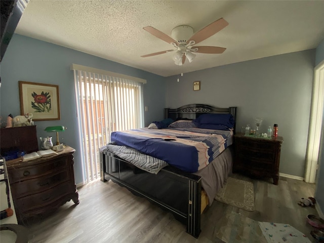 bedroom with ceiling fan, a textured ceiling, access to exterior, and light hardwood / wood-style floors