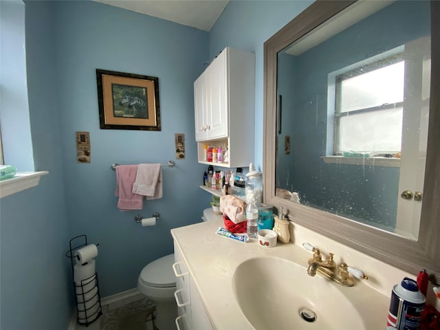 bathroom featuring vanity and toilet