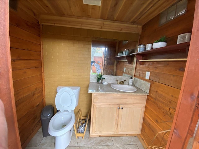 bathroom featuring wood walls, tile patterned flooring, vanity, toilet, and wooden ceiling