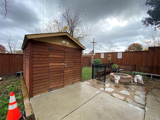 view of outbuilding with a fire pit