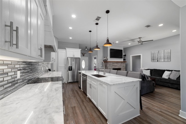 kitchen featuring appliances with stainless steel finishes, a breakfast bar, sink, and white cabinets