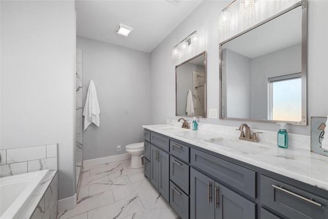 bathroom with vanity, toilet, and tiled tub