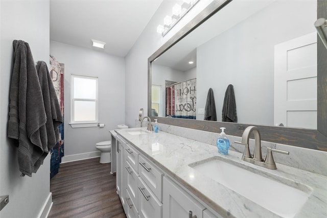 bathroom featuring a shower with curtain, vanity, wood-type flooring, and toilet