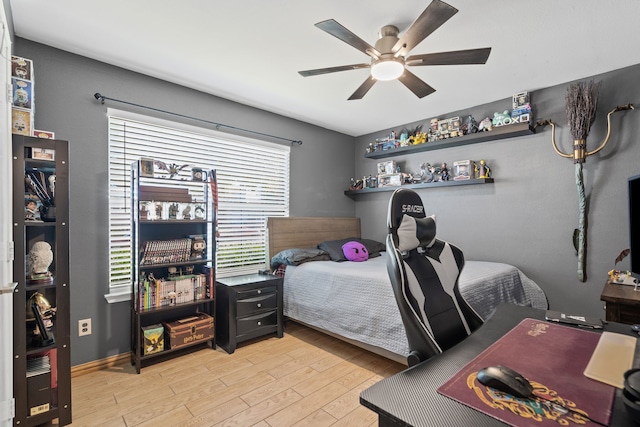 bedroom with light hardwood / wood-style flooring and ceiling fan