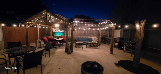 patio at twilight with a gazebo and an outdoor living space with a fire pit