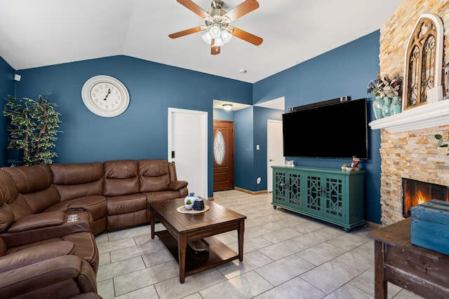 tiled living room with ceiling fan, a fireplace, and vaulted ceiling