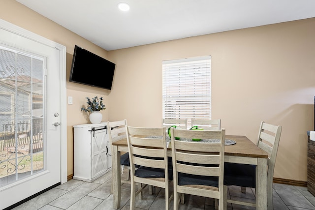 dining space featuring light tile patterned flooring