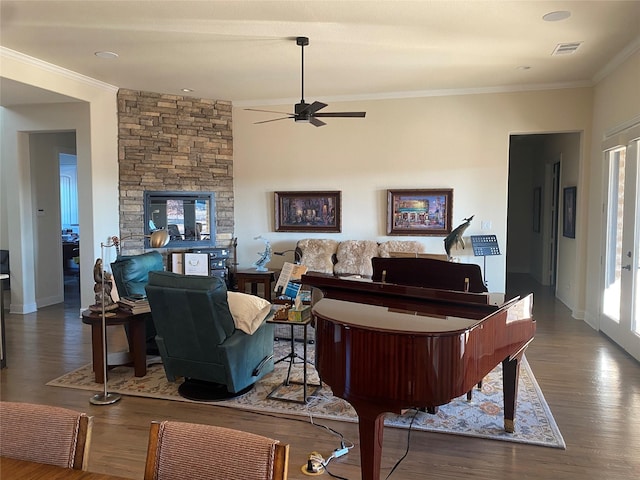 living room with dark hardwood / wood-style flooring, ornamental molding, and ceiling fan