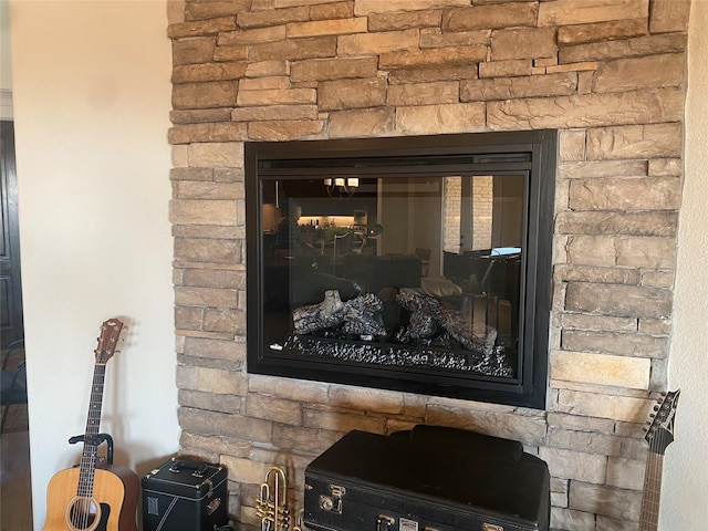 interior details featuring a stone fireplace