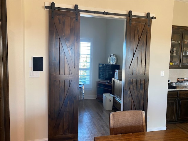 interior space featuring a barn door and dark hardwood / wood-style flooring