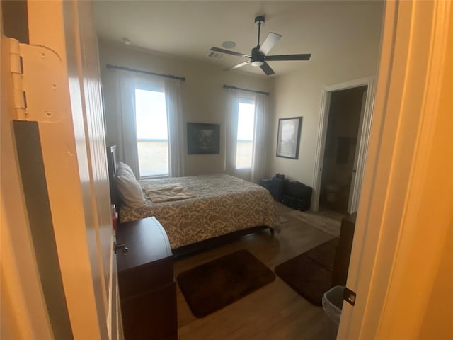 bedroom with ceiling fan and hardwood / wood-style floors