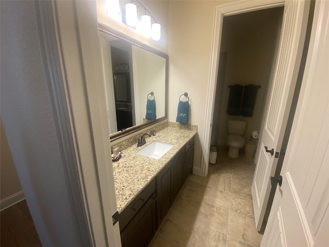 bathroom featuring vanity and toilet