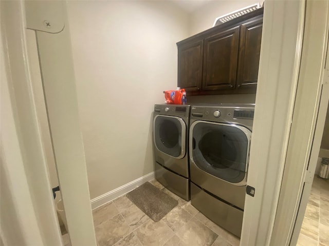 clothes washing area with cabinets and independent washer and dryer