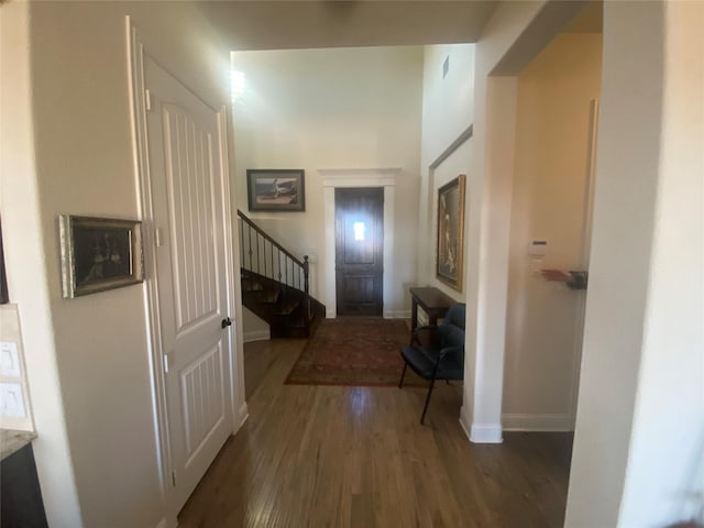 corridor with dark hardwood / wood-style floors