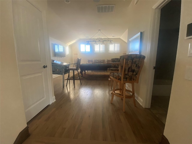 interior space featuring vaulted ceiling and dark hardwood / wood-style floors