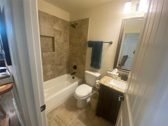 full bathroom featuring vanity, toilet, and tiled shower / bath combo