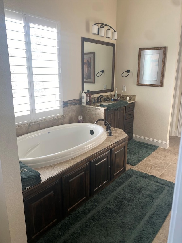 bathroom with vanity and a tub