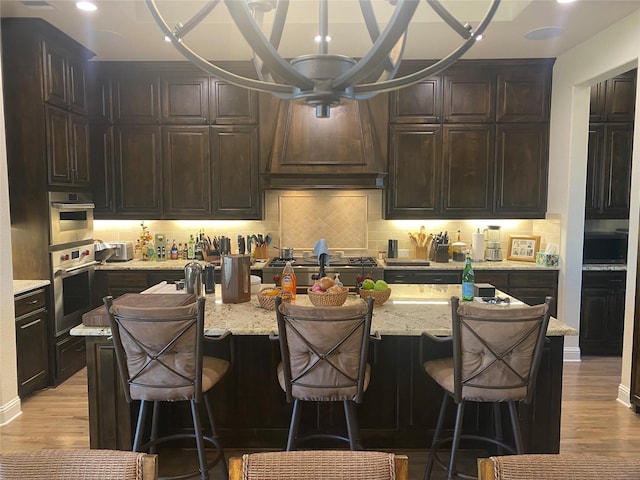 kitchen featuring a kitchen bar and a center island with sink