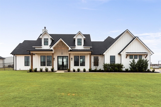 modern farmhouse style home with a front yard and french doors