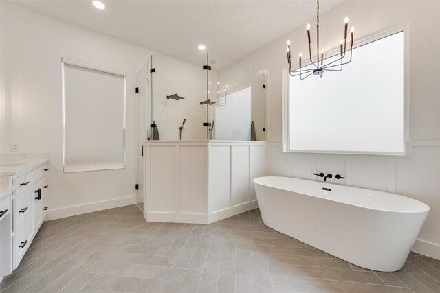 bathroom featuring vanity and shower with separate bathtub