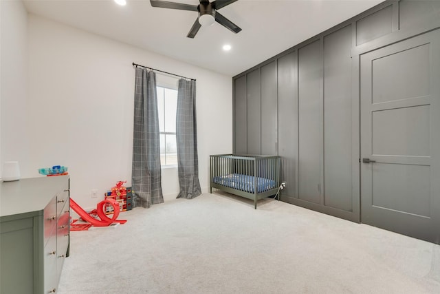 interior space with a crib and ceiling fan