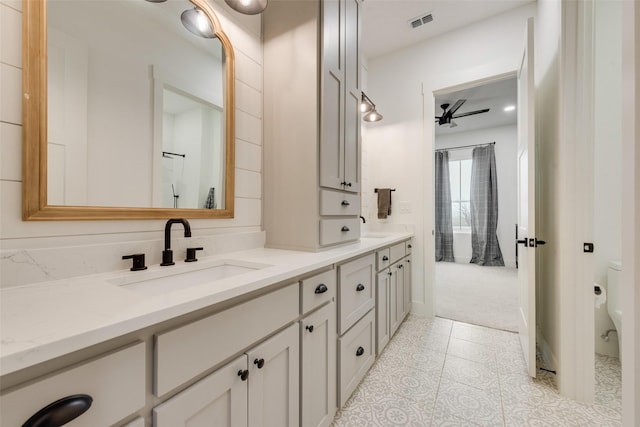 bathroom with vanity, ceiling fan, tile patterned flooring, and toilet