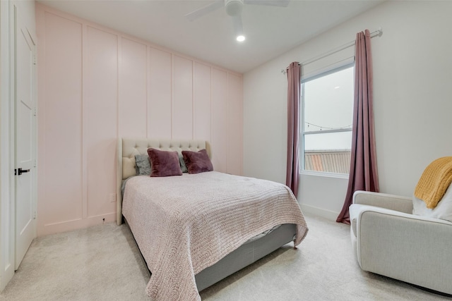 bedroom with light carpet and ceiling fan