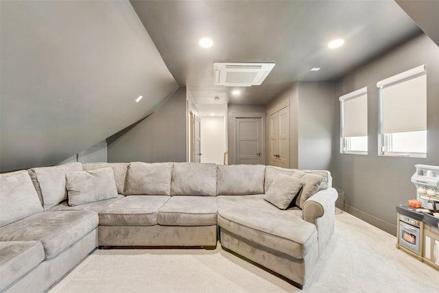 carpeted living room with lofted ceiling