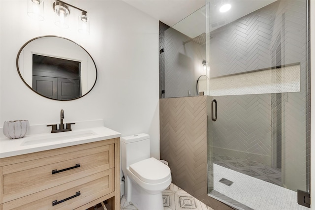 bathroom with an enclosed shower, vanity, and toilet