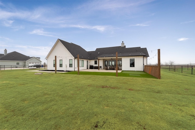 back of property featuring a yard and a patio