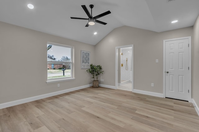 spare room featuring vaulted ceiling, ceiling fan, and light hardwood / wood-style flooring