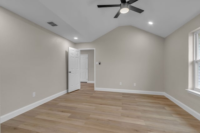 spare room featuring light hardwood / wood-style flooring, ceiling fan, and vaulted ceiling