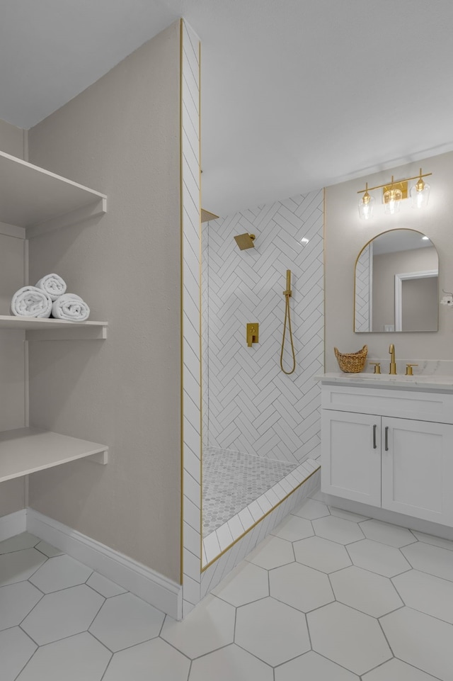 bathroom featuring a tile shower, vanity, and tile patterned floors