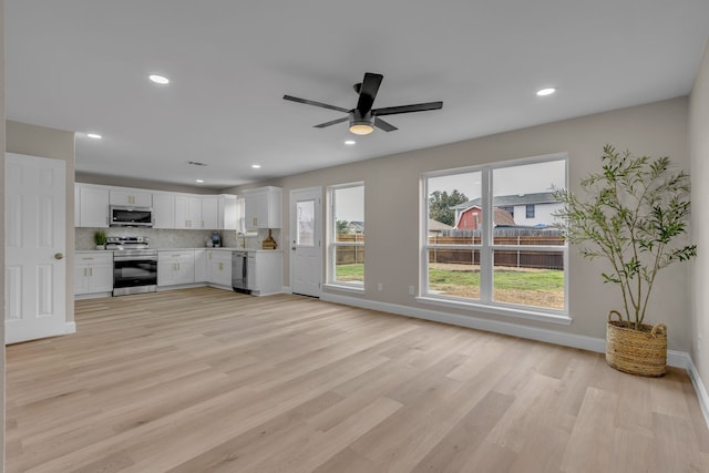 unfurnished living room with ceiling fan and light hardwood / wood-style flooring