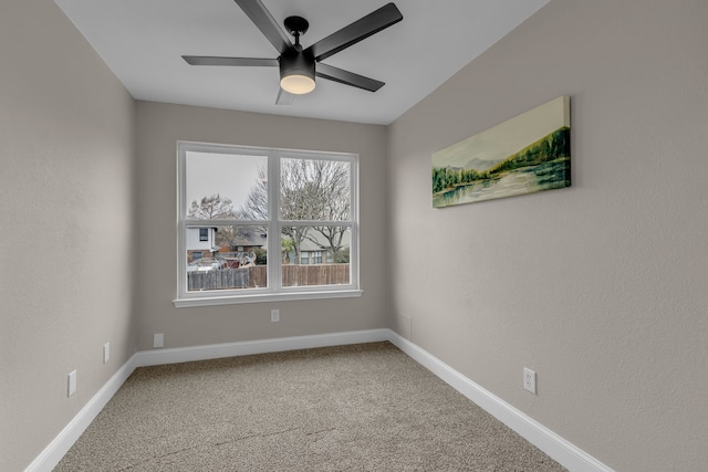 spare room with carpet and ceiling fan