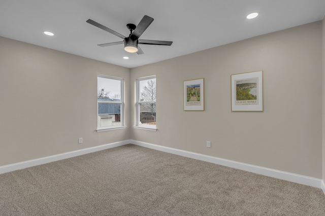 carpeted spare room featuring ceiling fan