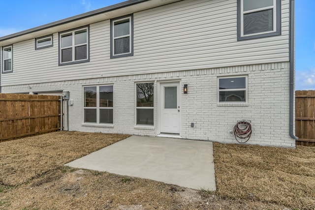 back of house with a patio area and a lawn