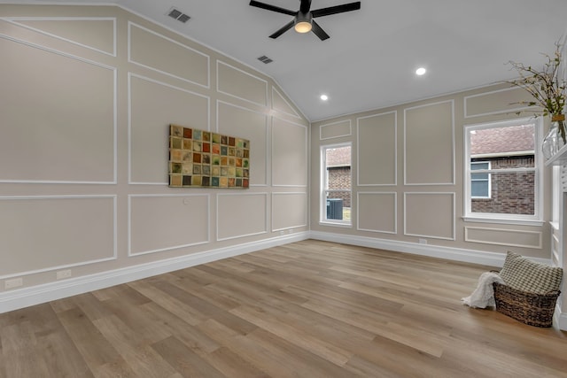 empty room featuring ceiling fan, lofted ceiling, and light wood-type flooring