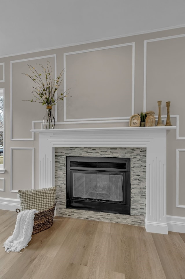 details featuring a tile fireplace and wood-type flooring