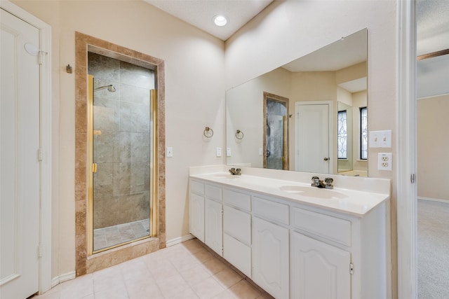 bathroom featuring vanity, tile patterned flooring, and a shower with door