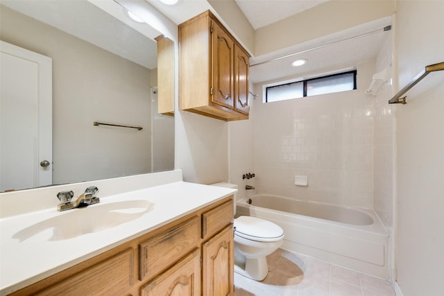 full bathroom with tile patterned floors, toilet, tiled shower / bath combo, and vanity