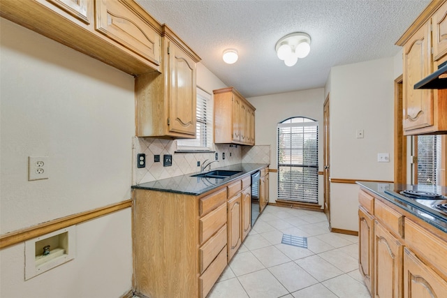 kitchen featuring sink, light tile patterned floors, stainless steel appliances, tasteful backsplash, and light brown cabinetry