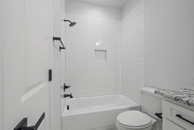 full bathroom featuring tiled shower / bath, vanity, and toilet