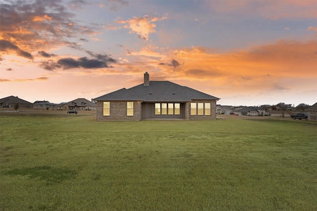 back house at dusk with a yard