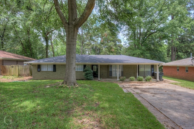 single story home featuring a front yard, brick siding, and fence