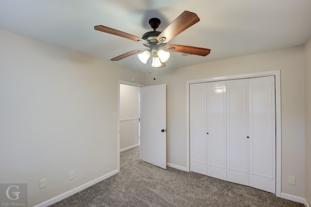 unfurnished bedroom featuring a ceiling fan, baseboards, a closet, and light colored carpet