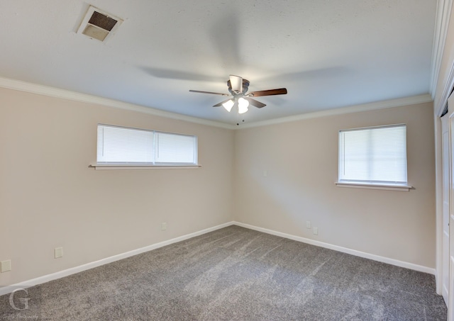 carpeted empty room with baseboards, ornamental molding, visible vents, and a healthy amount of sunlight