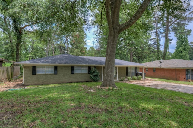 single story home with brick siding, fence, and a front yard