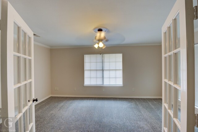 unfurnished living room with french doors, a brick fireplace, ornamental molding, ceiling fan, and carpet